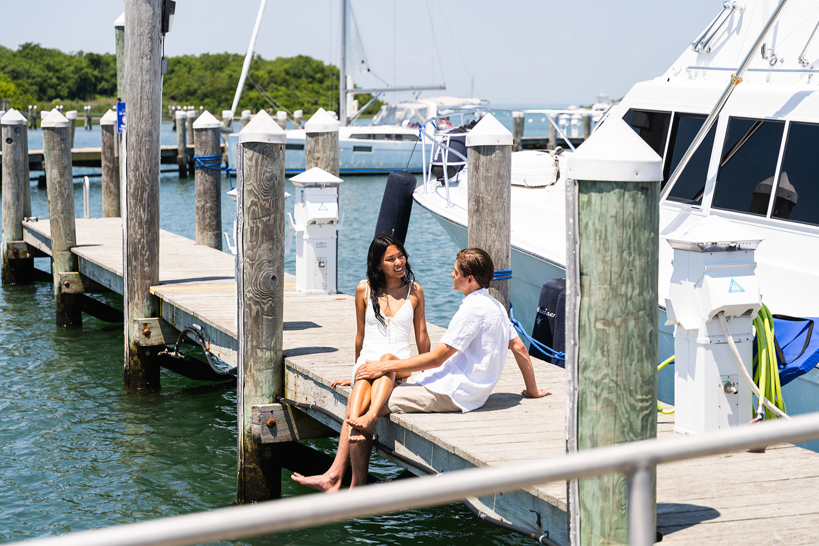 A couple sits on a quiet dock at Champlin's Marina and Resort